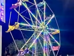 Ferris wheel rental standing tall over a festival midway