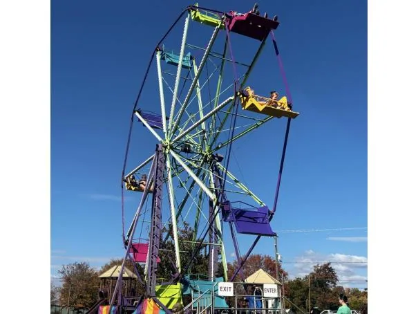 Ferris wheel rental viewed from the midway at an outdoor event