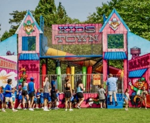 Kid Town Fun House carnival attraction Kid Town Fun House with bright midway panels, kid obstacles, and a two-story slide