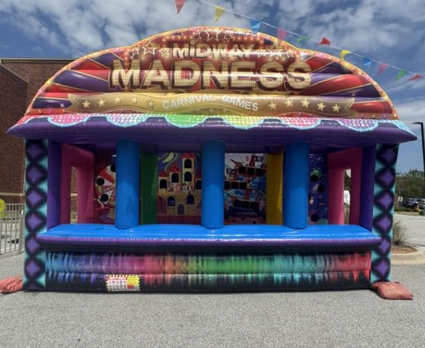 Midway Madness carnival game trailer with bright prize station graphics