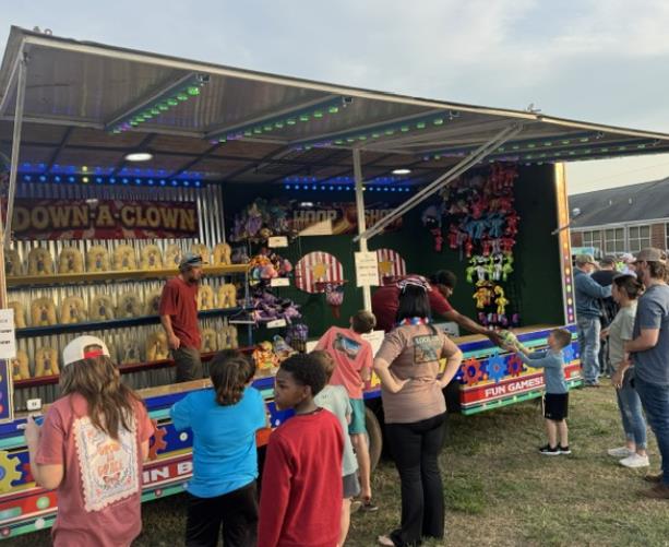 Prize Factory carnival game trailer with bright event lighting