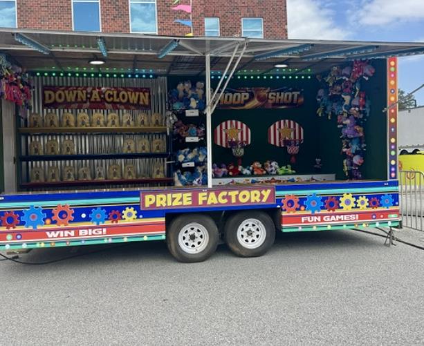 Prize Factory carnival game trailer lined with midway prizes