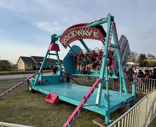 Shockwave carnival attraction with bright LED lighting and bold graphics