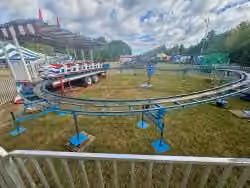 Kiddie roller coaster rental with bright track and carnival colors